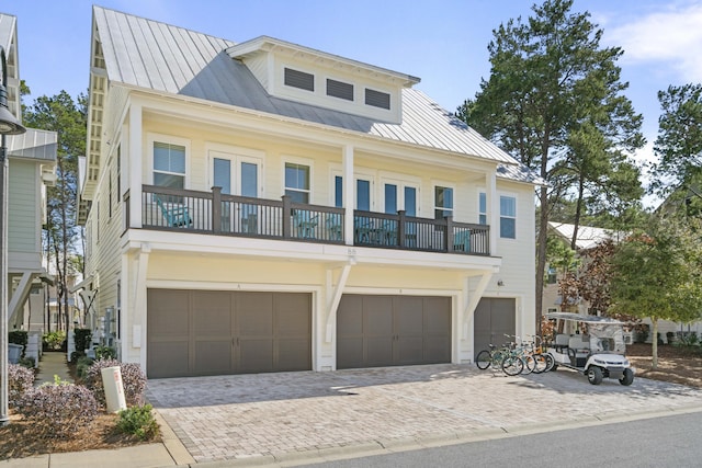 view of front of home with a garage and a balcony