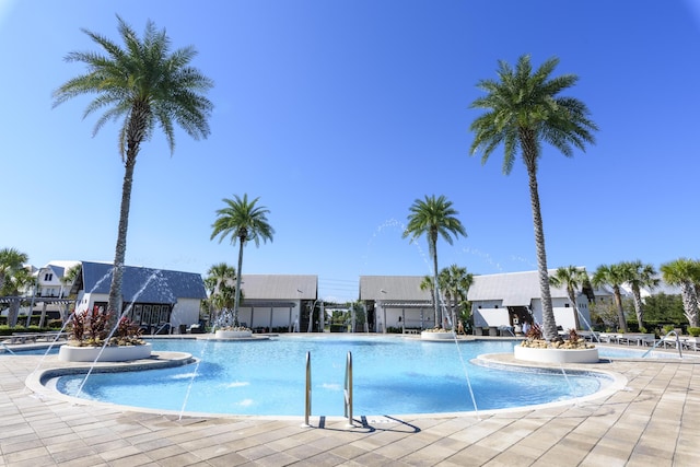 view of swimming pool with pool water feature