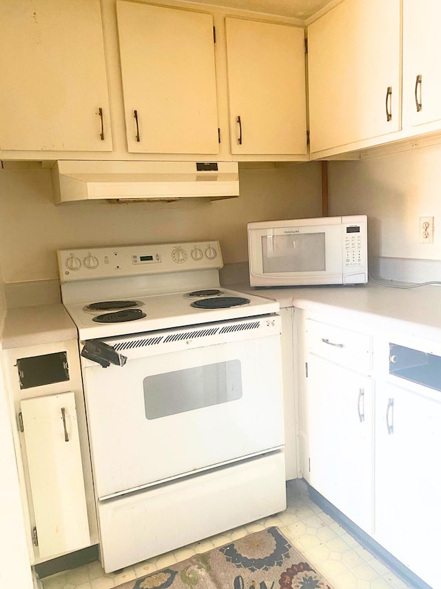 308 Miracle Strip Pkwy Unit 4C, Fort Walton Beach, FL 32548 - kitchen featuring white appliances, under cabinet range hood, light countertops, and light floors
