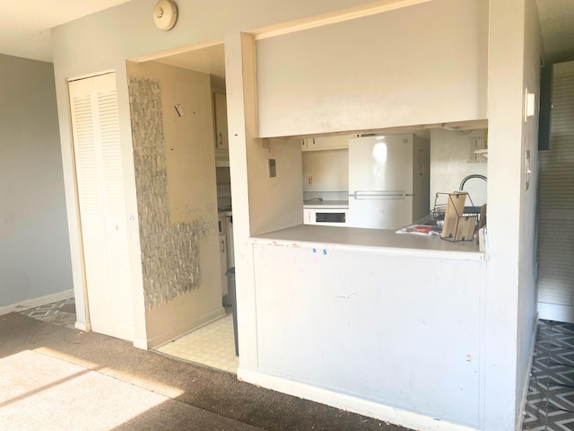 308 Miracle Strip Pkwy Unit 4C, Fort Walton Beach, FL 32548 - kitchen with freestanding refrigerator, baseboards, and a sink