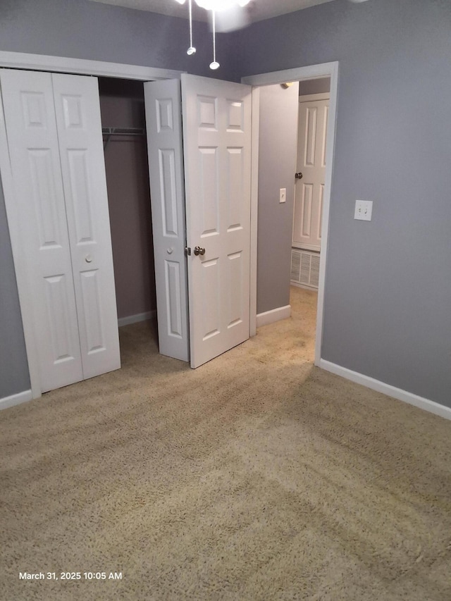 unfurnished bedroom with baseboards and a closet