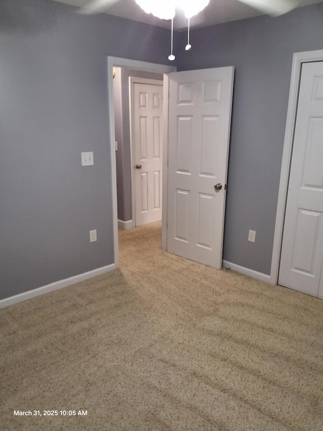 unfurnished bedroom with baseboards and carpet flooring