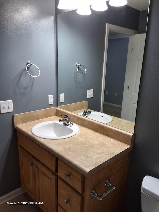 bathroom featuring toilet and vanity