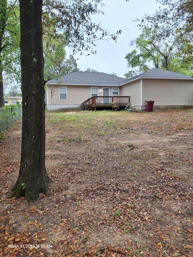 rear view of house with a wooden deck