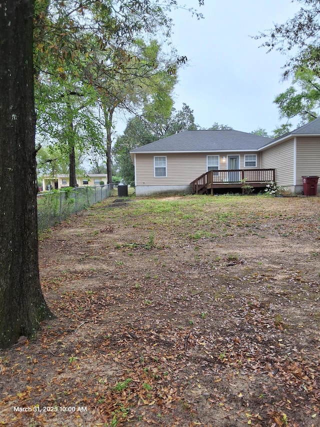 view of yard featuring fence and a deck