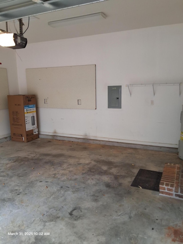 garage featuring water heater, electric panel, and a garage door opener