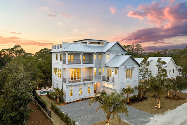 view of front of property with a garage and a balcony