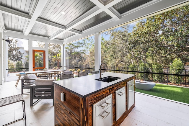 sunroom / solarium featuring coffered ceiling, sink, beam ceiling, and wooden ceiling