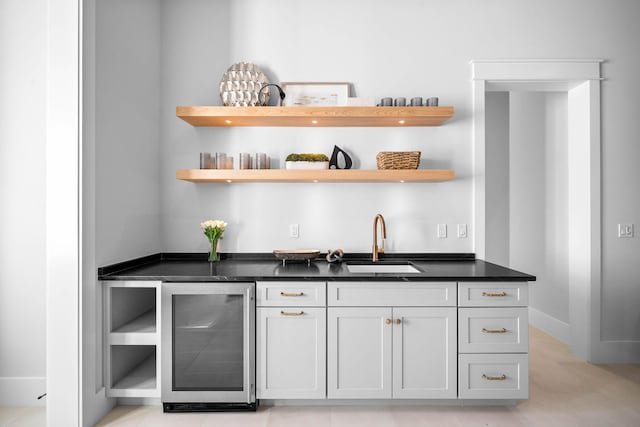 bar with white cabinetry, sink, and wine cooler