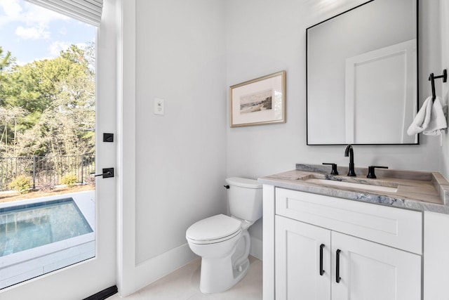 bathroom featuring tile patterned flooring, vanity, and toilet