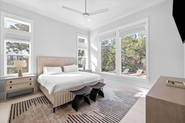 bedroom featuring crown molding, ceiling fan, multiple windows, and light tile patterned floors