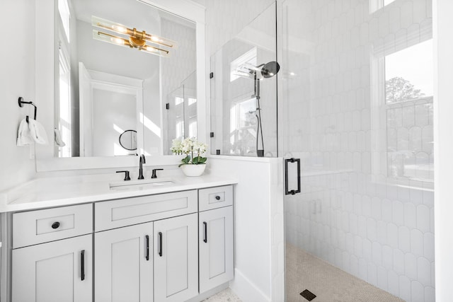 bathroom featuring vanity and a shower with shower door