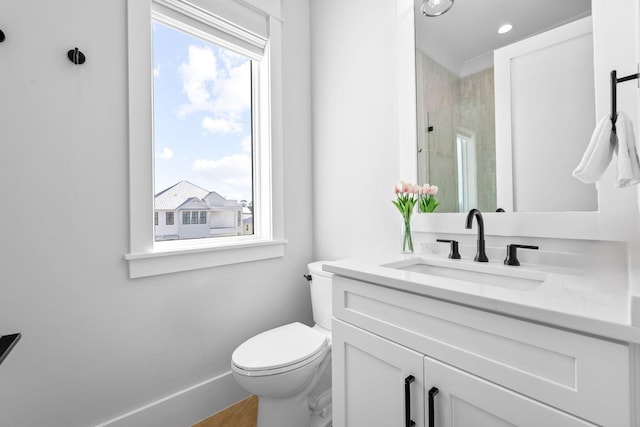 bathroom with vanity, toilet, and a shower with shower door