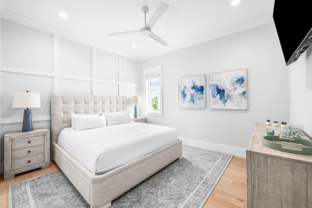 bedroom featuring hardwood / wood-style flooring, ornamental molding, and ceiling fan