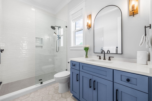 bathroom with vanity, tiled shower, and toilet