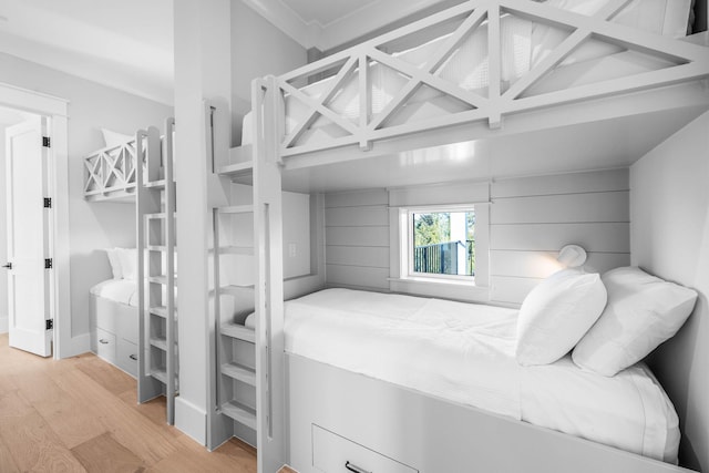 bedroom featuring coffered ceiling and light hardwood / wood-style flooring