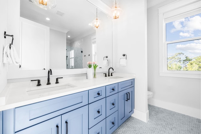 bathroom with crown molding, a shower with door, tile patterned flooring, vanity, and toilet