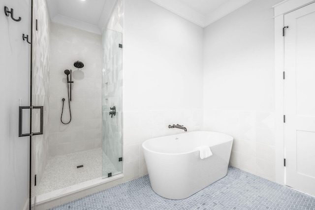 bathroom featuring tile patterned flooring, plus walk in shower, tile walls, and crown molding