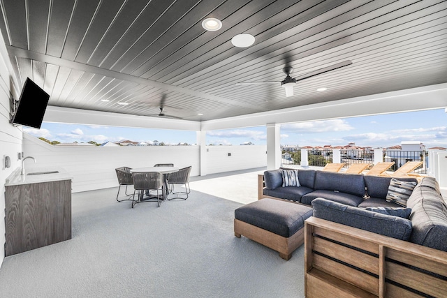 view of patio / terrace with an outdoor hangout area, sink, and ceiling fan