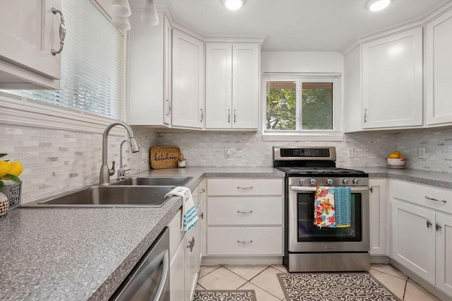 kitchen with white cabinetry, appliances with stainless steel finishes, sink, and light tile patterned floors