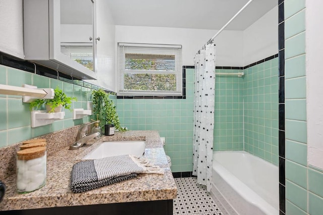 bathroom featuring vanity, tile walls, and shower / bath combo