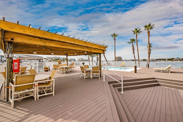 wooden deck with a community pool