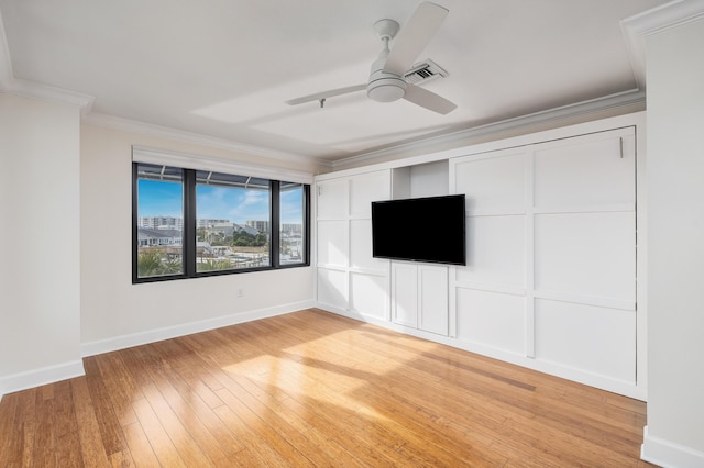 unfurnished room featuring crown molding, ceiling fan, and light wood-type flooring