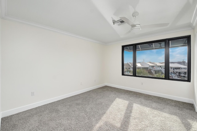 empty room with crown molding, carpet, and ceiling fan