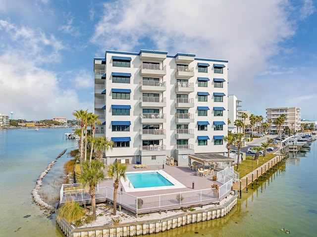 view of swimming pool with a water view and a patio area