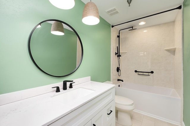 full bathroom with vanity, tile patterned flooring, tiled shower / bath combo, and toilet