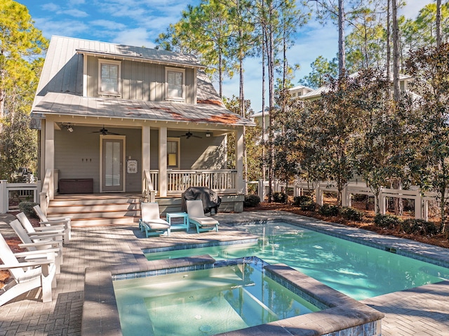 view of pool featuring a patio, ceiling fan, and an in ground hot tub