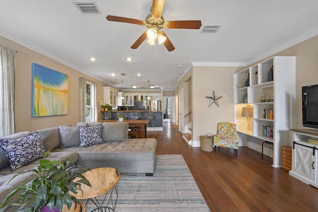 living room with crown molding, ceiling fan, and dark hardwood / wood-style flooring