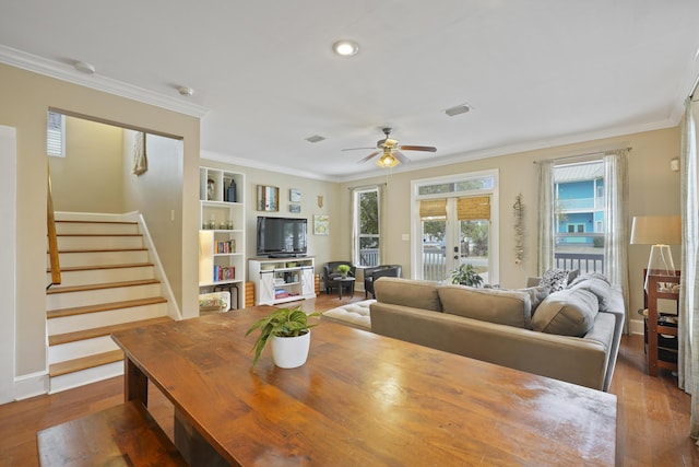 living room featuring crown molding, ceiling fan, hardwood / wood-style floors, and built in features