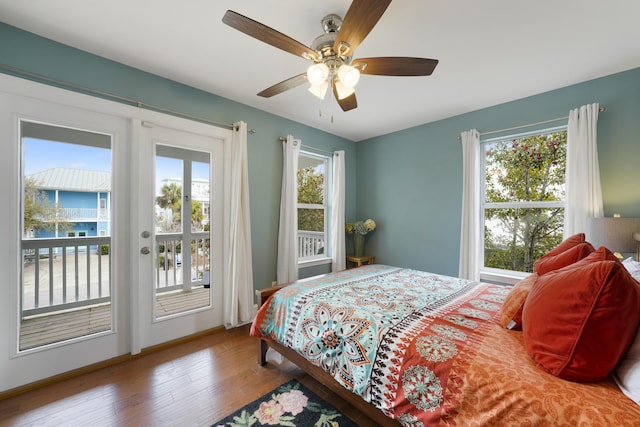 bedroom with access to exterior, wood-type flooring, and ceiling fan