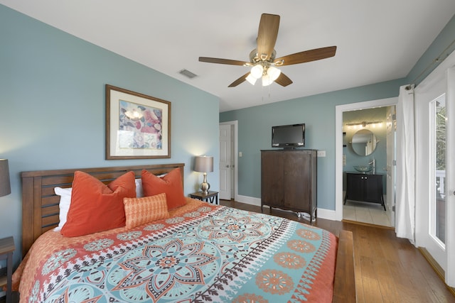 bedroom with connected bathroom, ceiling fan, and light wood-type flooring