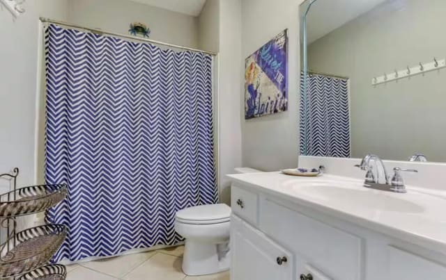 bathroom with vanity, tile patterned floors, and toilet