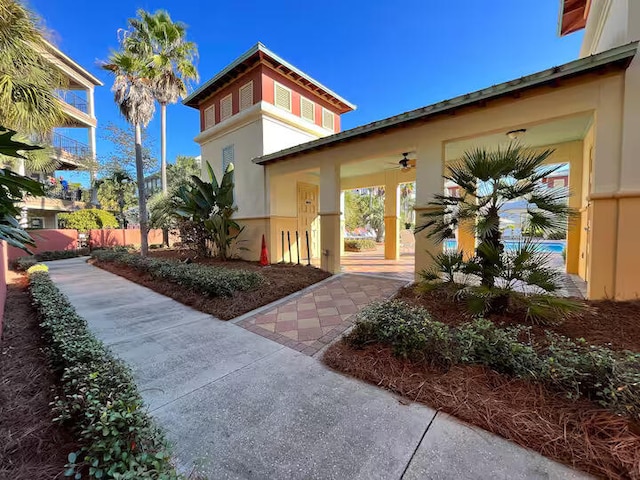 exterior space featuring ceiling fan