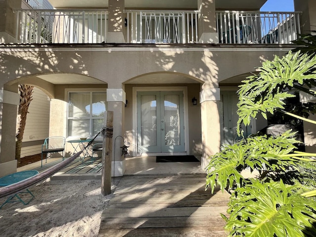 entrance to property with a balcony and french doors