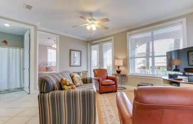 living room featuring crown molding, light tile patterned floors, and ceiling fan