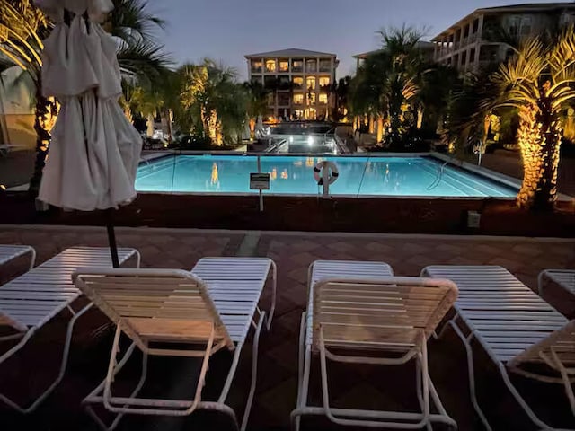 pool at dusk with a patio