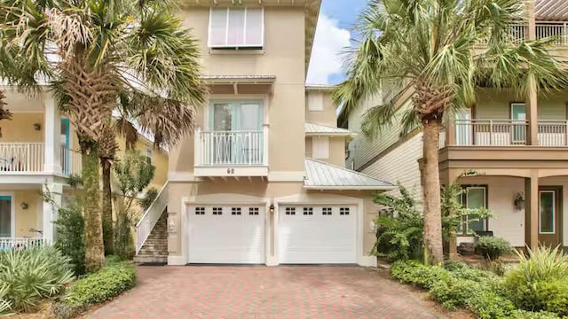 view of front of property featuring a garage and a balcony