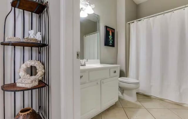 bathroom featuring tile patterned flooring, vanity, and toilet