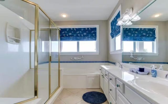 bathroom featuring vanity, plus walk in shower, and tile patterned flooring