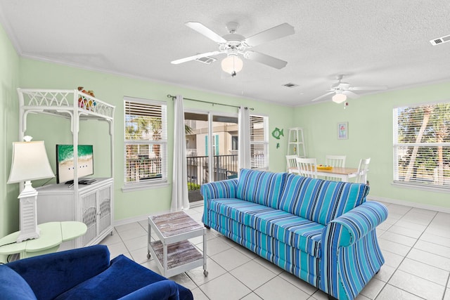 tiled living room featuring crown molding, ceiling fan, and a textured ceiling