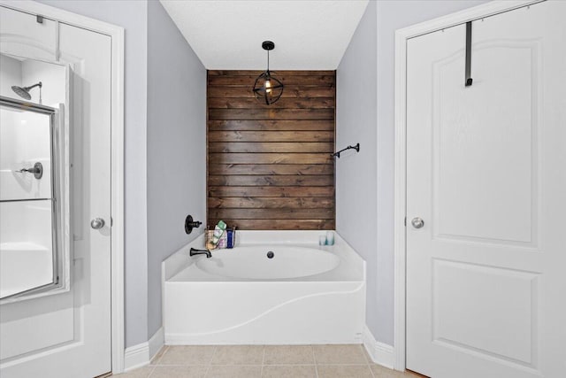 full bath featuring a shower with shower door, tile patterned flooring, a textured ceiling, wood walls, and a bath