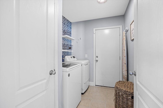 laundry area with light tile patterned floors, laundry area, and washer and clothes dryer