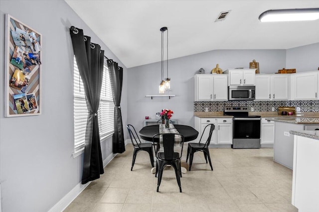 kitchen featuring visible vents, white cabinets, decorative backsplash, appliances with stainless steel finishes, and decorative light fixtures