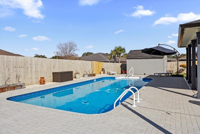 view of pool featuring a fenced backyard, a patio, a fenced in pool, and an outdoor structure