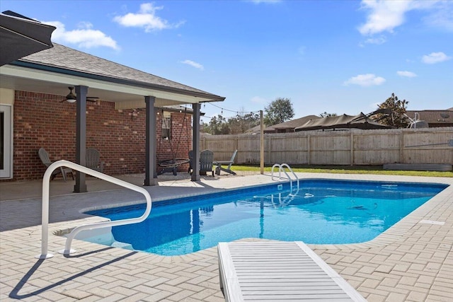 view of pool featuring a fenced in pool, a fenced backyard, a patio, and ceiling fan