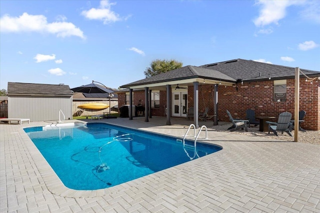 view of swimming pool featuring a patio area, ceiling fan, and a fenced in pool